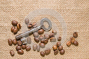 Vintage key and coffee beans on cloth