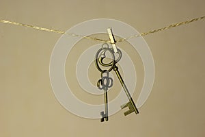 Vintage key hanging on a rope on a gold background