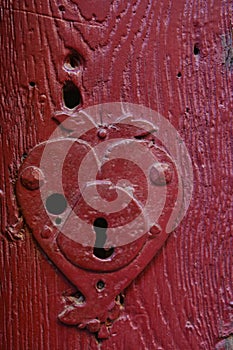 Vintage keyhole in an old red door
