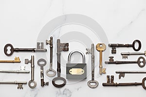 Vintage keys and padlock overhead lay flat composition. Security concept