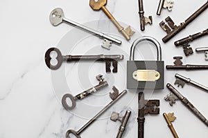 Vintage keys and padlock overhead lay flat composition. Security concept