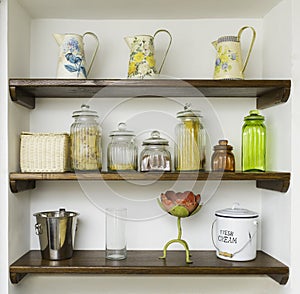 Vintage kitchen shelves with jars, jugs and pots