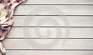 Vintage kitchen tablecloth on rustic wooden table made of white wood planks. Textured background with copy space