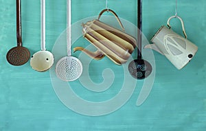 Vintage kitchen utensils and coffee pots,food and drink, nostalgic items,hanging on teal background,free copy space