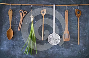 Vintage kitchen utensils and green onions,