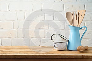 Vintage kitchen utensils and tableware on wooden table photo