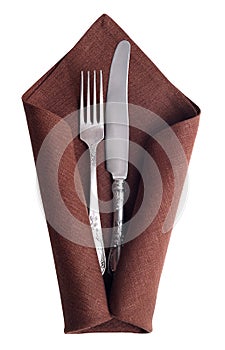 Vintage knife and fork at napkin isolated.