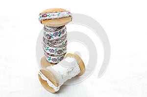Vintage lace on the wooden bobbin on white background