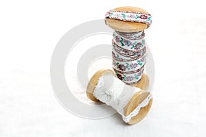 Vintage lace on the wooden bobbin on white background