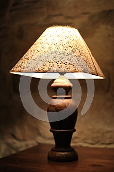 A vintage lamp beside a bed