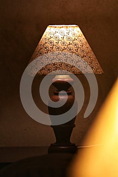 A vintage lamp beside a bed