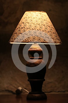 A vintage lamp beside a bed