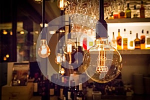 Vintage lamp bulb with bar or cafe night abstract background