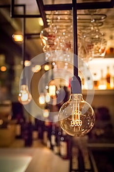 Vintage lamp bulb with bar or cafe night abstract background