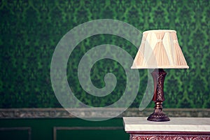 Vintage lamp on green pattern background on chimney