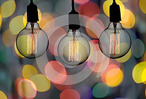 Vintage lamp or Modern Light bulb hang on ceiling in bokeh background.