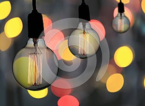 Vintage lamp or Modern Light bulb hang on ceiling in bokeh background.