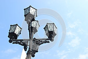 Vintage lamppost on blue sky background