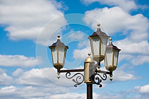 Vintage lantern on blue sky background