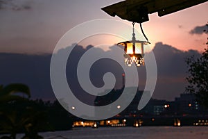 Vintage lantern hanging by riverside