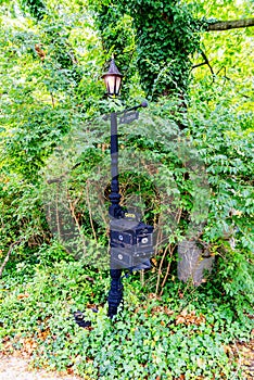 Vintage lantern on a pole with mailboxes