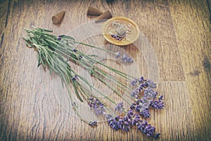 Vintage lavender flowers and incense aroma cones on a wooden table