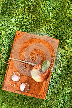 Vintage leather book, glasses and apple