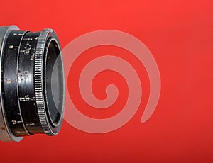 Vintage lens on red background