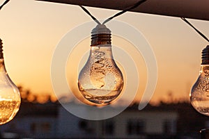 Vintage light bulbs on a the sunset background - Solar power concept