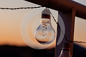 Vintage light bulbs on a the sunset background - Solar power concept