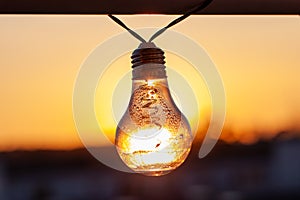 Vintage light bulbs on a the sunset background - Solar power concept