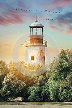 Vintage lighthouse at sunset in the Danube Delta