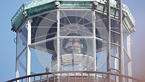 Vintage lighthouse tower, retro light house, old fashioned beacon, fresnel lens.