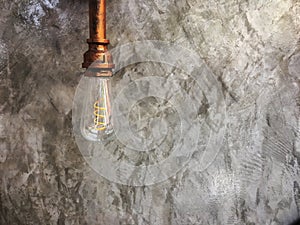 Vintage lighting lamp hang in front of cement wall at loft.