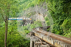 Vintage locomotive passes Death railway in Kanchanaburi, Thailand.