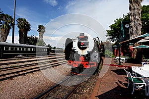 Vintage locomotive steam train against blue sky photo