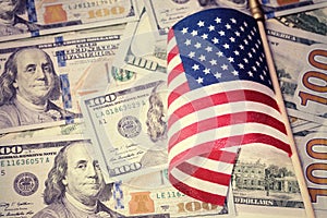Vintage look. American flag on US dollar bills background. Financial concept.