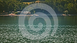 A vintage looking lake background with tranquil water stream on foreground