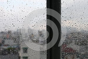 Vintage looking Urban scene seen through a window in a rainy day