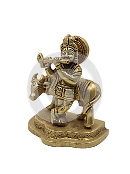 vintage lord krishna statue playing flute beside a cow