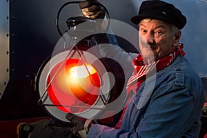 Vintage machinist with old locomotive lamp