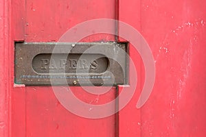 Vintage mail drop in a red door