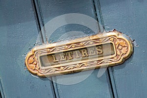 Vintage mailbox inlaid in a blue wooden door