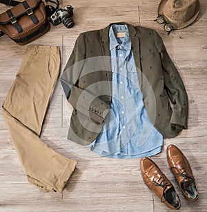 Vintage male clothing and accessories on the wooden background