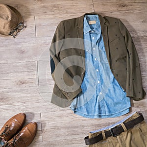 Vintage male clothing and accessories on the wooden background