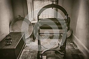 Vintage mangle and starch in laundry room in mansion in 19th century, sepia style photography