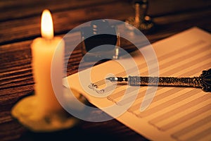 Vintage manuscript - writing musical notes in candlelight