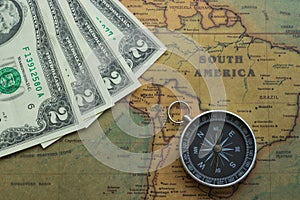 Vintage map of South America with two dolor bills and a compass, close-up