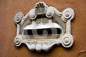 Vintage marble mailbox on the wall of a house