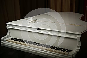 Vintage mask is on a white piano. photo